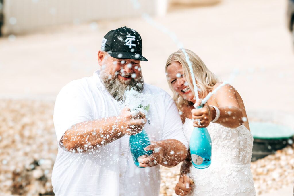 Champagne spray moment at the Lubbs wedding party at Camden on the Lake Resort