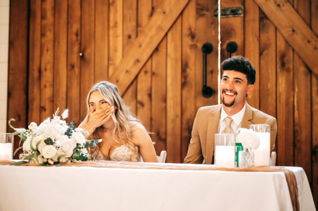 Newlyweds laughing during the reception at Briarwood Hills near the Lake of the Ozarks