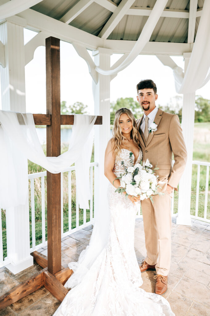 Ethan and Taylor smiling together after their wedding ceremony at Briarwood Hills Wedding and Event Venue