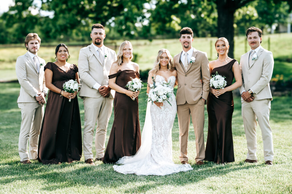 Wedding party standing in a field.