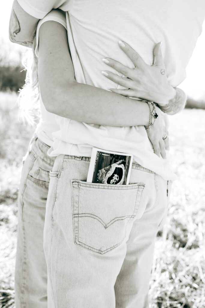 Couple celebrating pregnancy during maternity photos