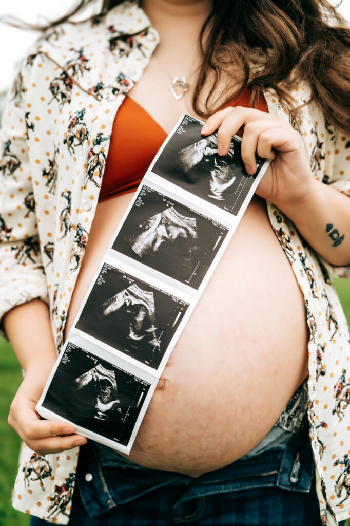 Close up maternity photo of mom holding baby ultrasound