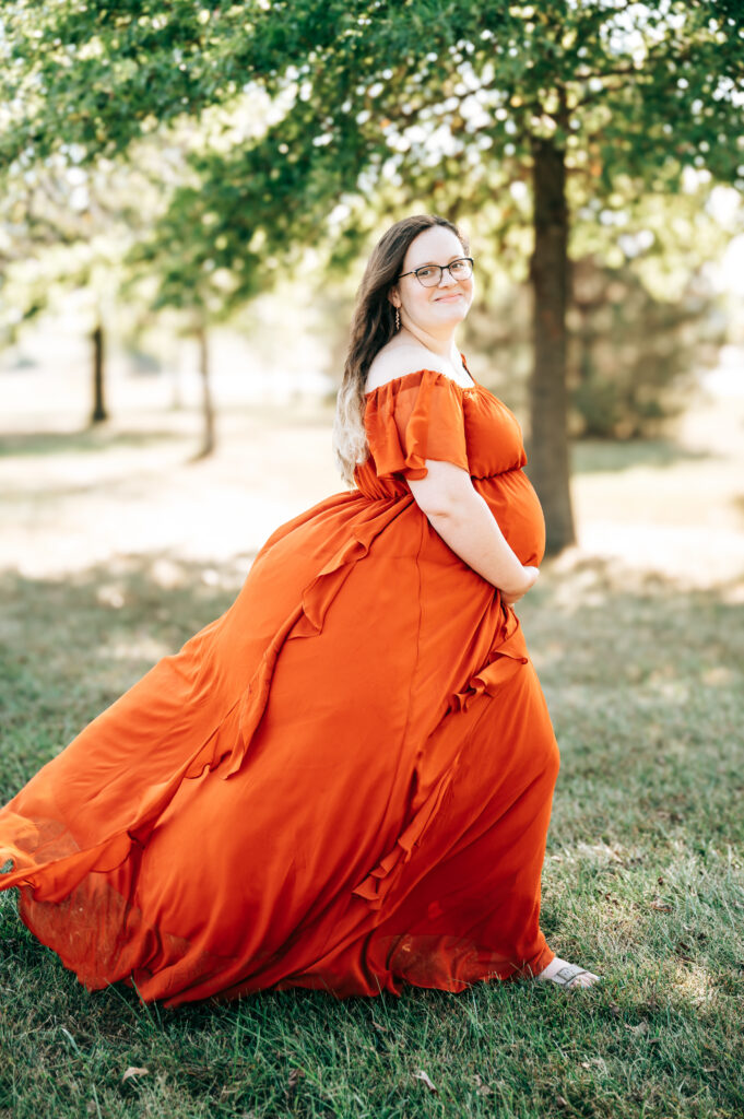 Expecting mom wearing a maternity dress for outdoor photos